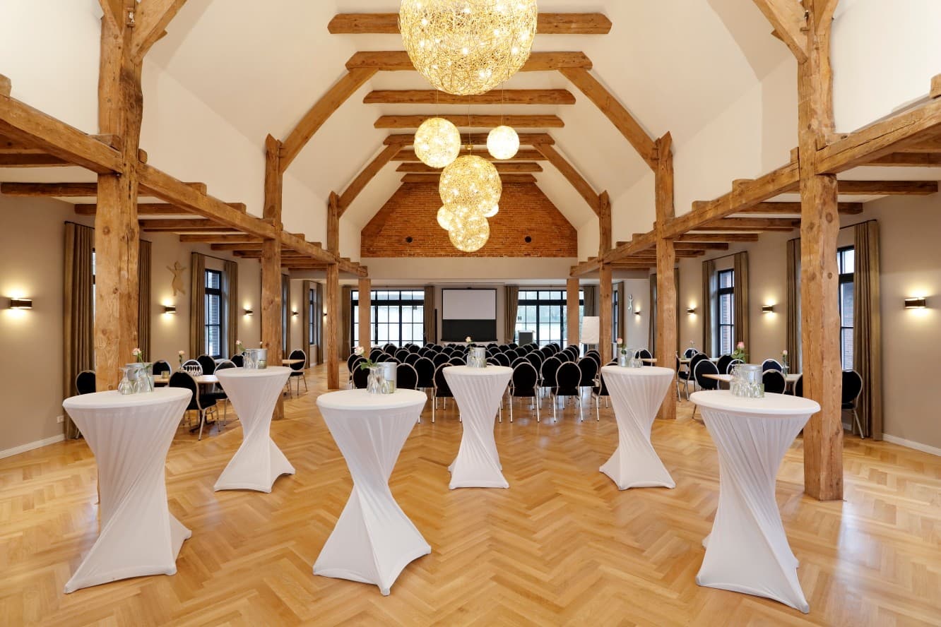 Saal im Patentkrug mit Stehtischen, Reihenbestuhlung, Leinwand und leuchtenden Lichtkugeln