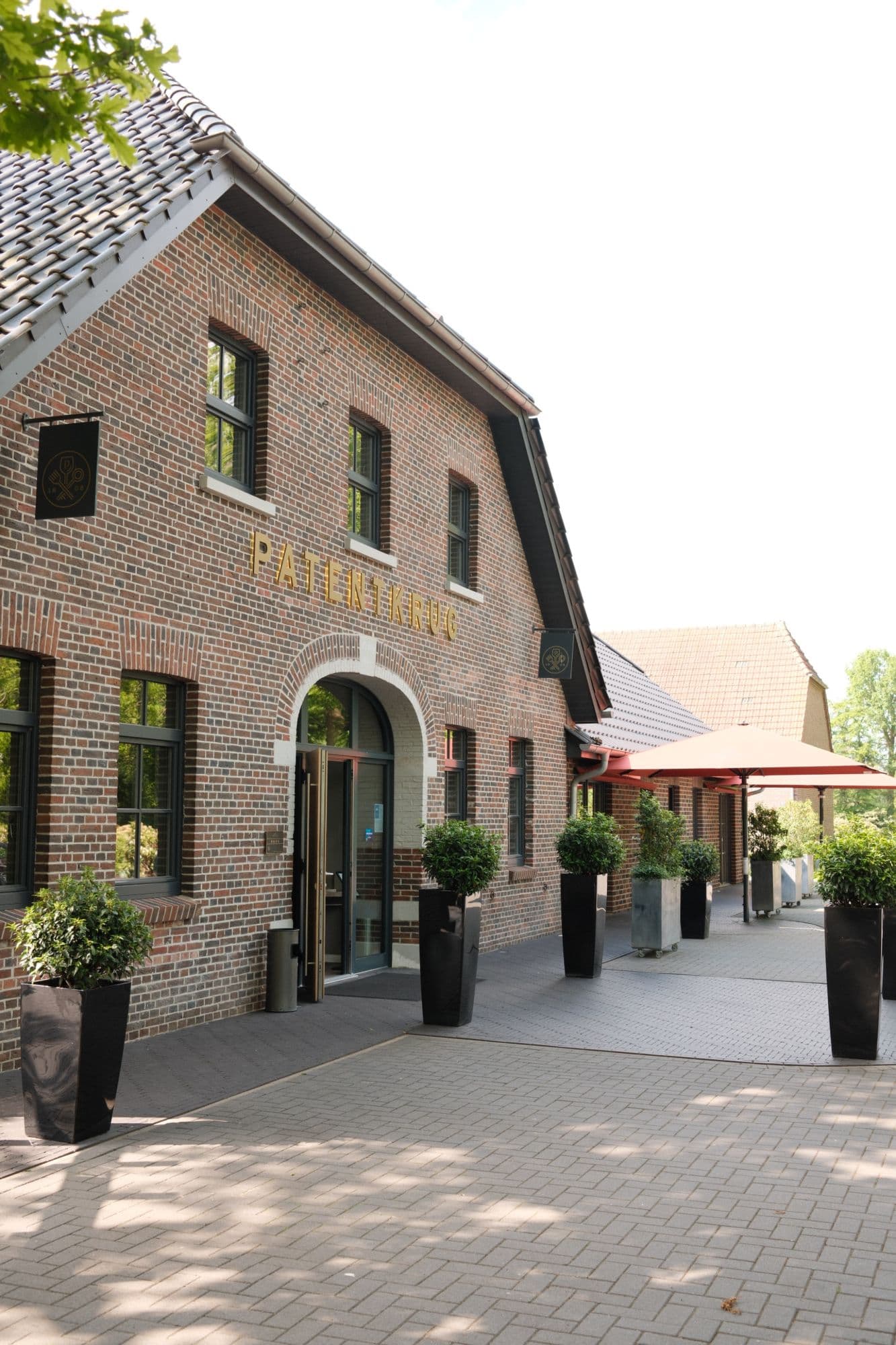 Backsteinfassade des Patentkrug mit goldenem Schriftzug und Rundbogeneingang